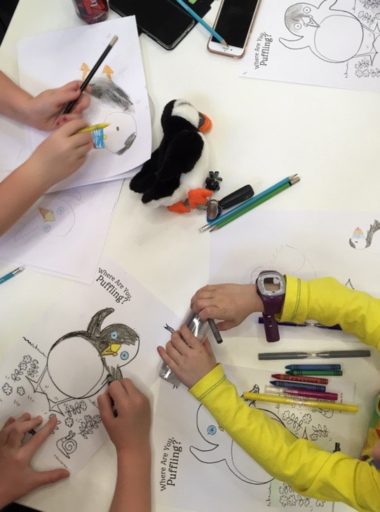 Children drawing puffins