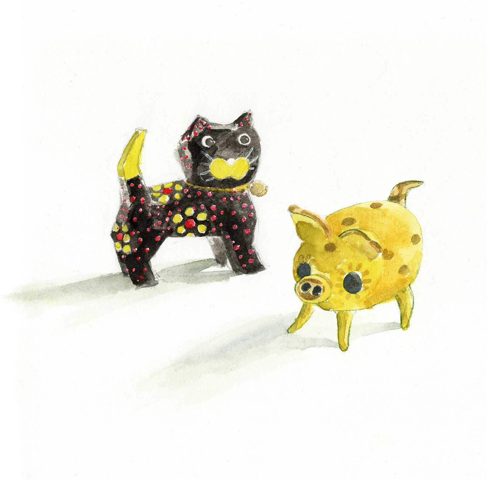 A wooden painted cat beside a small ceramic yellow gold spotted pig