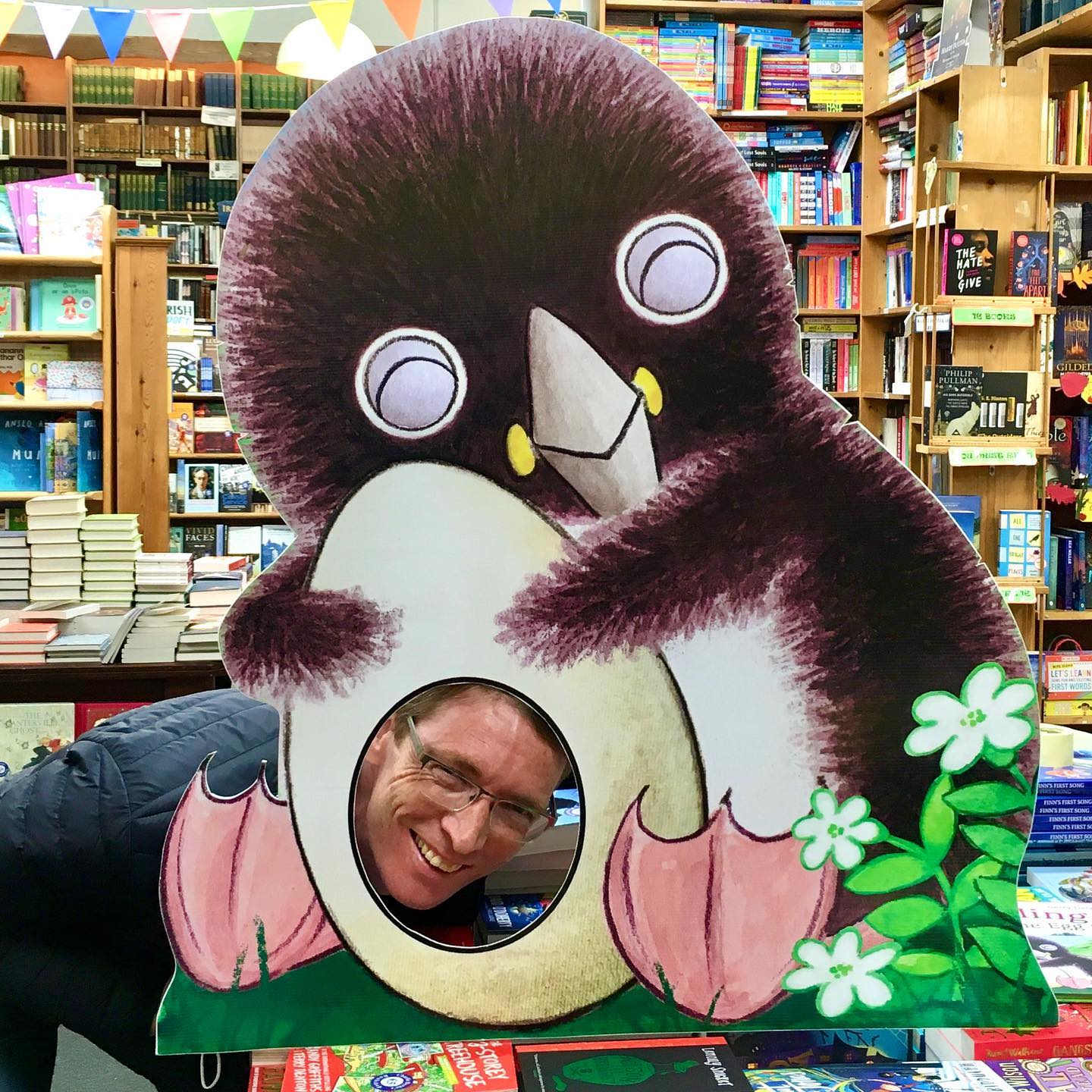 Large stand up cutout of Puffling hugging the egg in Charlie Byrne's bookshop Galway